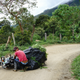 Peasants don’t have access to the equipment and infrastructure that would make growing legal crops profitable. Here, a worker tries to lift a weed-laden motorcycle after taking a spill on the dirt road.